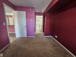 Plush carpeting, two-panel interior doors, and a built-in shelving unit - 