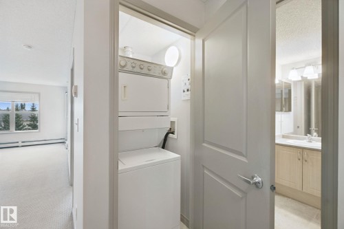 Stackable laundry appliances in a dedicated utility closet - #406 11449 Ellerslie Rd Sw, Edmonton, AB 