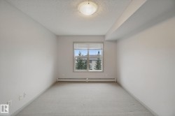 Neutral wall finishes, textured ceiling, window with blinds, baseboard heating, and ceiling-mounted light fixture - 
