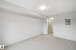 Neutral-toned carpeting, white painted walls, and a flush mount ceiling light fixture - 