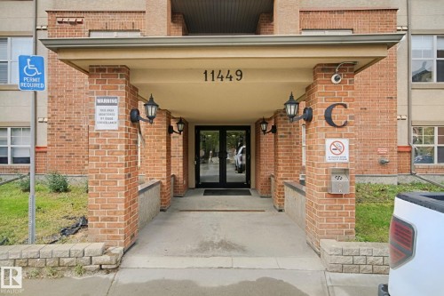 Brick exterior with a covered entry - #406 11449 Ellerslie Rd Sw, Edmonton, AB 