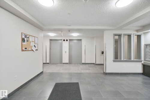 Tile flooring, flush-mount ceiling lighting, dual elevators, built-in mailboxes - #406 11449 Ellerslie Rd Sw, Edmonton, AB 