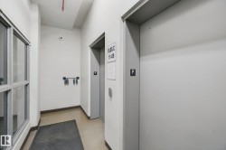 Elevator access within the building, featuring block wall construction and industrial-style window framing - 