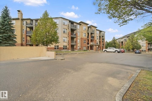 Multi-story building featuring brick and stucco siding - #406 11449 Ellerslie Rd Sw, Edmonton, AB 