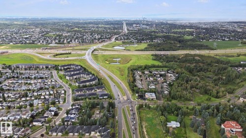 Expansive suburban landscape with residential developments and mature tree lines - #406 11449 Ellerslie Rd Sw, Edmonton, AB 