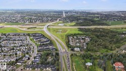 Expansive suburban landscape with residential developments and mature tree lines - 