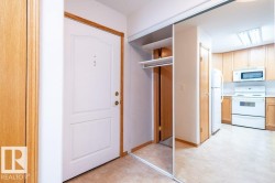 Entryway featuring a paneled door, built-in closet with mirrored sliding doors.  The back of the closet has a secret door leading to the Den. - 