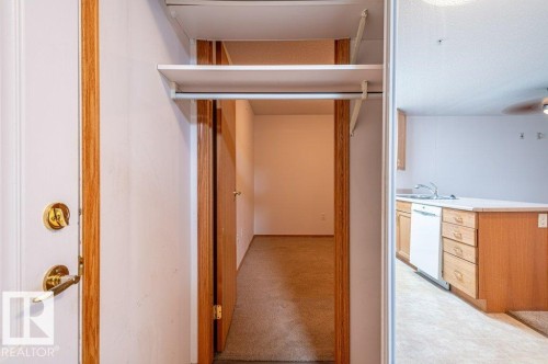 Entryway closet with secret door leading into the Den. - #203 8912 156 St Nw, Edmonton, AB 