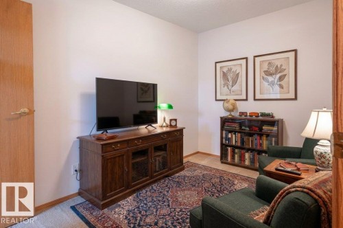 This Den has a second (secret) entrance from the back of the front closet.  And a 2nd door into the hallway.  This room has been virtually staged. - #203 8912 156 St Nw, Edmonton, AB 