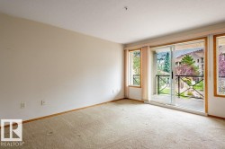 Room for lots of furniture in this large living room with patio doors opening to a balcony with black metal railing OVERLOOKING THE POND - 