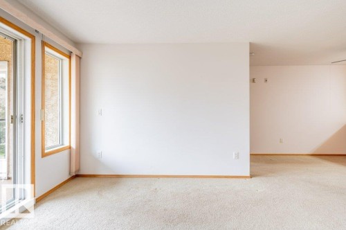 Another view of the living room showing just how much space there is for furniture placement. - #203 8912 156 St Nw, Edmonton, AB 