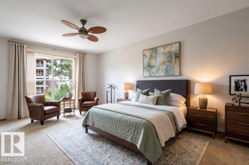 Large Primary bedroom with a French door to the  balcony. Light & bright with large windows.  This room has been Virtually Staged. - #203 8912 156 St Nw, Edmonton, AB 