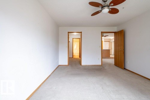 Primary bedroom looking into the walk-thru closet & into the ensuite. - #203 8912 156 St Nw, Edmonton, AB 