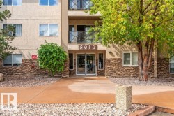 Multi-story building with textured stucco facade and stone accents - 