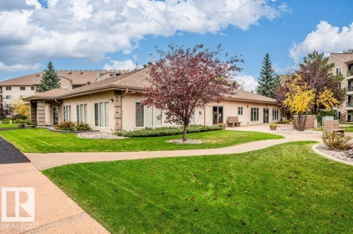 Expansive green lawn areas with established trees and shrubbery - #203 8912 156 St Nw, Edmonton, AB 