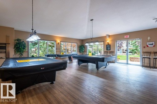 Recreation Centre features a games room with featuring pool tables, and other games. - #203 8912 156 St Nw, Edmonton, AB 