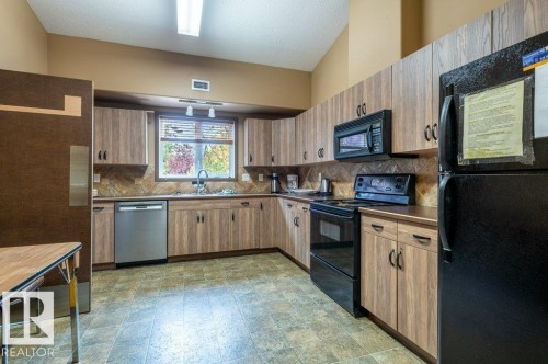 Recreation Centre kitchen for monthly pot-luck dinners and catered events. - #203 8912 156 St Nw, Edmonton, AB 