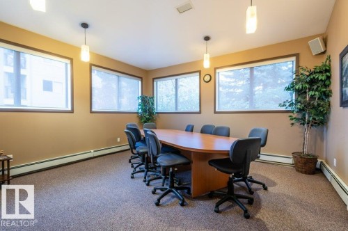 Conference room with wall-to-wall carpeting, multiple windows, and suspended pendant lighting fixtures - #203 8912 156 St Nw, Edmonton, AB 