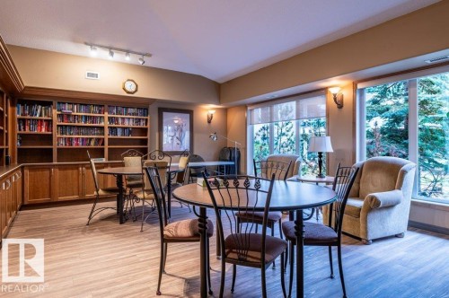 This library is a beautiful, cozy space with Built-in wood cabinetry with integrated shelving.  Ideal for small group gathering, quiet time reading, making puzzles, etc. - #203 8912 156 St Nw, Edmonton, AB 