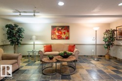 Stone tile flooring with varied tones, textured wainscoting, and recessed ceiling lights & comfortable seating.  This is also were the access to the Guest Suite is. - 