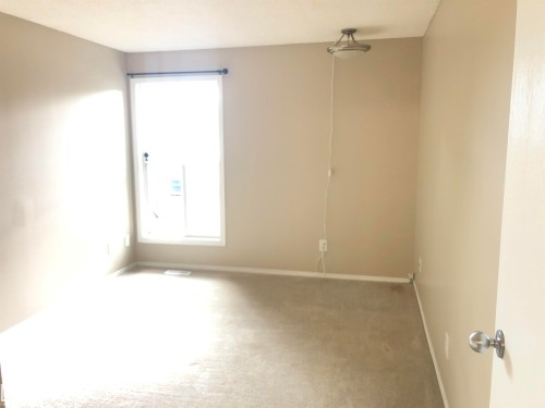 Neutral-toned walls complement the carpeted flooring - #68 1503 Mill Woods Rd E Nw, Edmonton, AB 