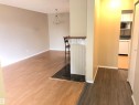 Wood-finish flooring throughout, pendant light fixture, and a built-in bar - #68 1503 Mill Woods Rd E Nw, Edmonton, AB 