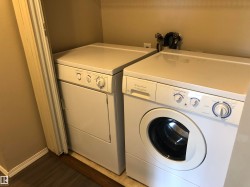 Dedicated laundry area with a front-loading washing machine and a separate dryer - 