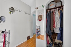 Recessed closet with a built-in shelving unit and clothing rod - 
