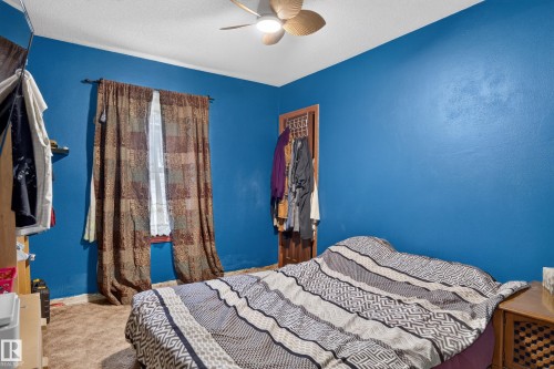 Textured blue walls with a single window - 12309 80 Street Nw, Edmonton, AB 