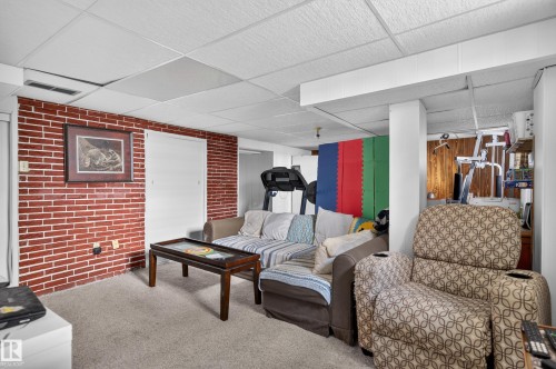 Red brick accent wall with two white doors - 12309 80 Street Nw, Edmonton, AB 