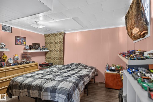 Wood-finish flooring, white ceiling panels, and pink paneling - 12309 80 Street Nw, Edmonton, AB 