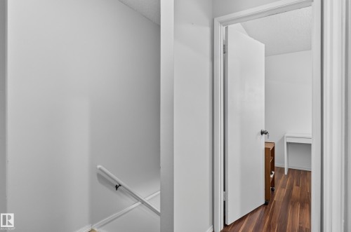 Wood-finish flooring extending into the room - 130 Woodstock Nw, Edmonton, AB 