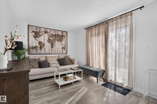 Wood-finish flooring throughout the space - 130 Woodstock Nw, Edmonton, AB 
