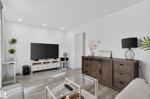Recessed ceiling lighting, light wood-finish flooring, and white painted walls - 130 Woodstock Nw, Edmonton, AB 