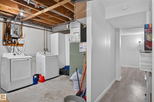 Dedicated laundry area featuring a washer and dryer - 130 Woodstock Nw, Edmonton, AB 