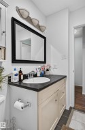 Vanity with dark countertop and integrated sink - 