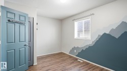 Wood-finish flooring, single window with blinds, and a built-in light fixture - 