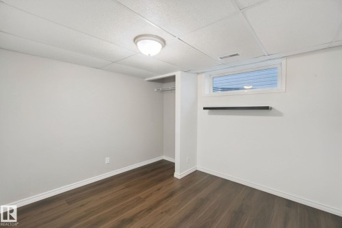 Recessed window with a floating shelf, wood-finish flooring, and built-in closet storage - 2117 36 Avenue Nw, Edmonton, AB 