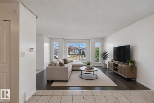 Tile flooring at entry, wood-finish flooring, and multiple large windows - 2117 36 Avenue Nw, Edmonton, AB 