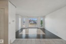 Bay windows, light-toned wall finishes, and a combination of dark and light-toned floor tiles - 2117 36 Avenue Nw, Edmonton, AB 