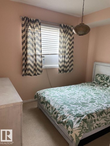 Single window with horizontal blinds and a window-mounted unit - #103 10346 117 St Nw, Edmonton, AB 