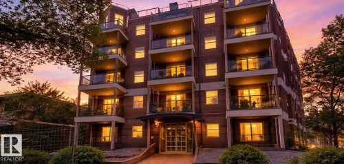 Brick exterior building with multiple balconies featuring glass railings - #103 10346 117 St Nw, Edmonton, AB 