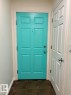 Aqua paneled door with a peephole, chrome hardware, and white trim - #103 10346 117 St Nw, Edmonton, AB 
