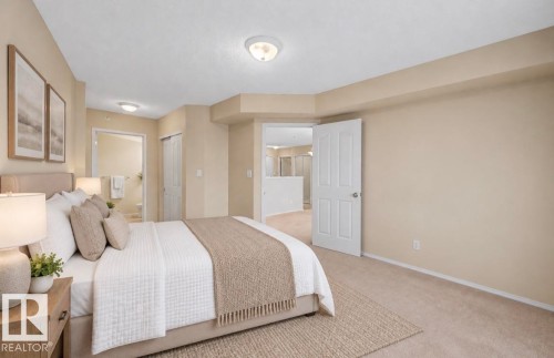 Neutral wall color, wall-to-wall carpeting, overhead flush-mount lighting, and solid-core interior doors - #505 7839 96 St Nw, Edmonton, AB 