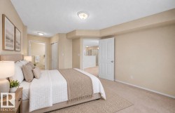 Neutral wall color, wall-to-wall carpeting, overhead flush-mount lighting, and solid-core interior doors - 