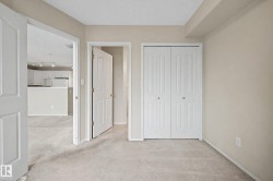 Neutral tone wall color, light-colored carpet, white bi-fold closet doors, and white interior doors - 