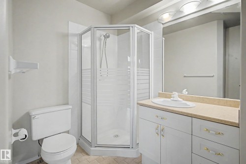 White vanity with a neutral-toned countertop and an integrated sink - #505 7839 96 St Nw, Edmonton, AB 
