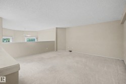 Carpeted flooring throughout, neutral painted walls, and textured ceilings - 