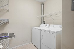 Laundry area featuring tiled flooring, wire shelving, and appliance hookups - 