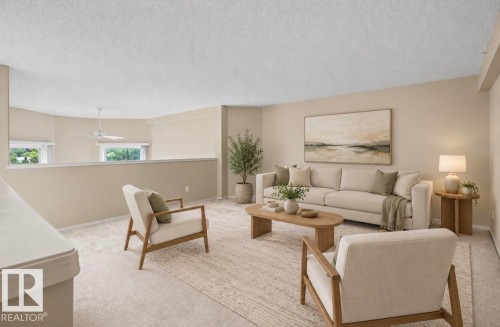 Carpeted living area with neutral wall tones and a ceiling fan - #505 7839 96 St Nw, Edmonton, AB 